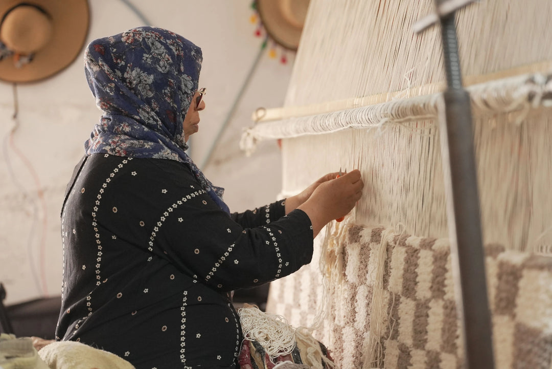 Berber weaver artisan making geometric square rug on a loom