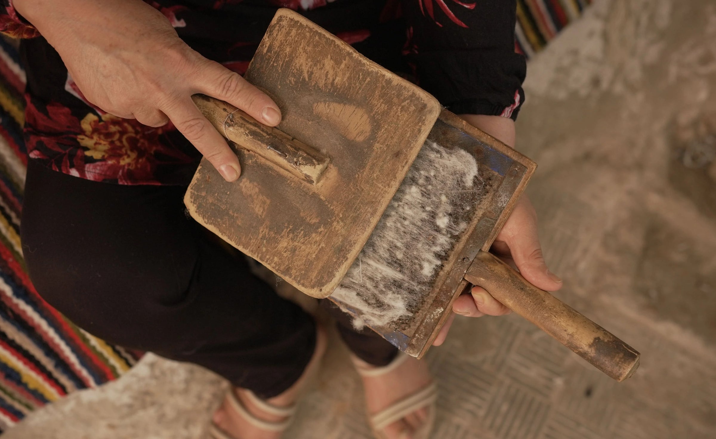 Berber weaver woman working with natural wool with traditional tool