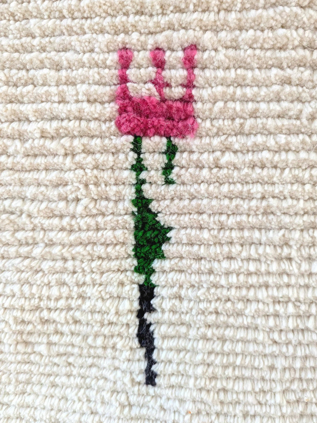 Pink and green fork pattern on traditional berber rug