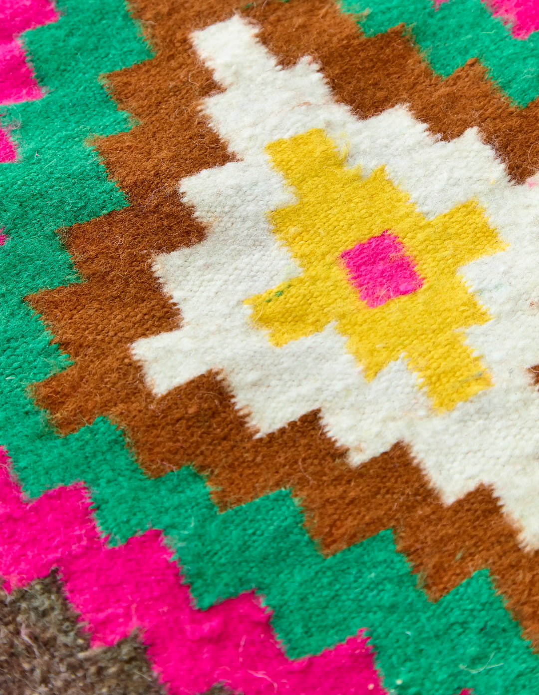 Close up on a colourful pattern on a flat weave berber rug